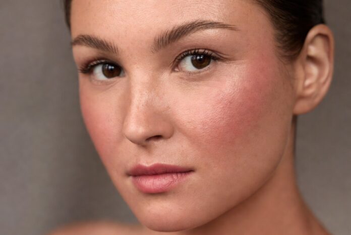 Boyfriend Blush Trend 2026 Model wearing boyfriend blush trend makeup with naturally flushed cheeks and soft skin-focused beauty styling