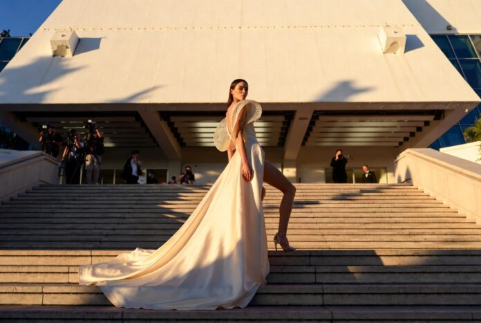 Cannes 2026 Red Carpet Fashion — Best Dressed Looks Model in a sculptural ivory silk gown ascending the Cannes Film Festival red carpet steps at golden hour representing the best dressed looks at Cannes 2026