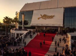 Cannes Film Festival 2026 Is Fueling Oscar Buzz for Prestige Movie Contenders Guests ascending the Cannes Palais des Festivals red carpet steps at golden hour representing the Cannes Film Festival 2026 Oscar buzz and prestige film awards season