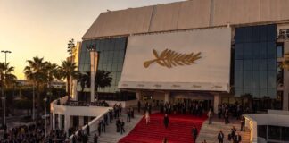 Cannes Film Festival 2026 Is Fueling Oscar Buzz for Prestige Movie Contenders Guests ascending the Cannes Palais des Festivals red carpet steps at golden hour representing the Cannes Film Festival 2026 Oscar buzz and prestige film awards season