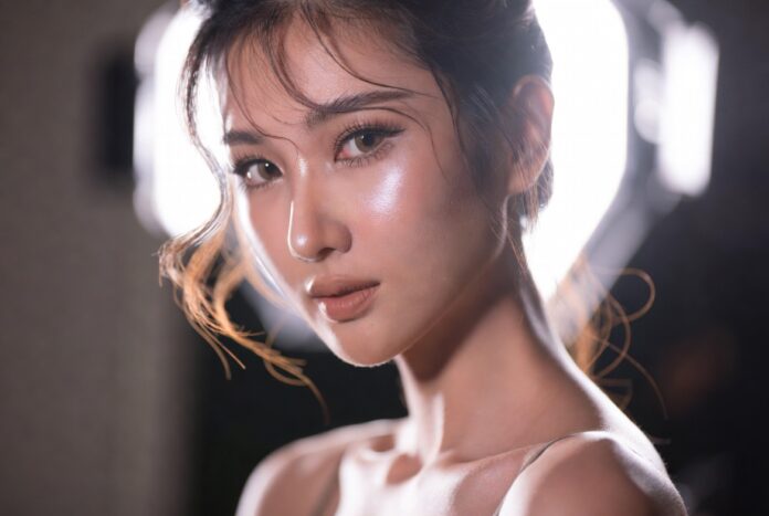 Model wearing Charlotte Tilbury Airbrush Flawless Foundation with modern skin-first makeup styling