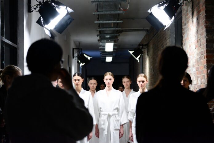 Fashion Week Models: Who Gets Booked and Why — Runway Magazine Fashion week models lined up backstage before a runway show, illustrating who gets booked for fashion week and why