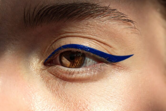 Graphic Liner: From Runway to Real Life — Runway Magazine Model with bold graphic liner eye look — floating cobalt line above the crease — representing Runway Magazine's complete guide to graphic liner from runway to real life