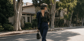Kaia Gerber’s Minimalist Street Style Is Defining the New Model-Off-Duty Uniform Kaia Gerber in a minimalist off-duty outfit featuring a black lacy blouse, navy tailored trousers, and black ballet flats on a Los Angeles street in 2026.