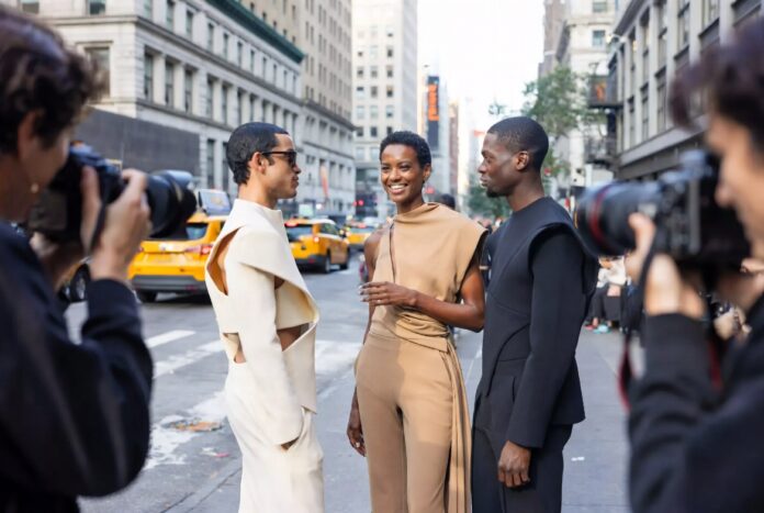 The Best Looks Outside the Shows — Runway Magazine Fashion week attendees in tailored architectural street style looks on the pavement outside a New York Fashion Week venue, representing Runway Magazine's best NYFW street style Spring 2026 coverage
