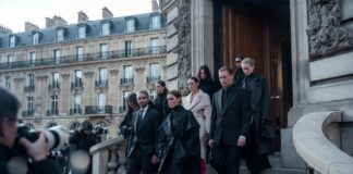 Elegantly dressed fashion professionals arriving at a Paris Fashion Week show venue, illustrating the Paris Fashion Week attendee guide by Runway Magazine