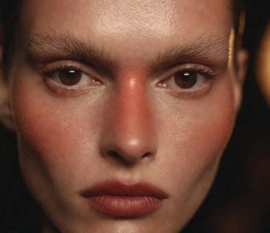Runway Makeup Trends 2026: The Looks Defining the Season Model with runway makeup trends 2026 showing flushed skin and blurred lip representing Runway Magazine's complete breakdown of the season's five defining beauty directions