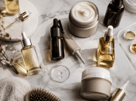 Premium scalp care and biotech haircare products arranged on marble surface in editorial flat lay