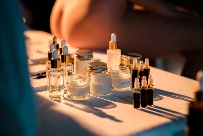 Luxury skincare products arranged on a backstage beauty table at a fashion week show, representing the runway model skincare secrets and routines revealed by Runway Magazine