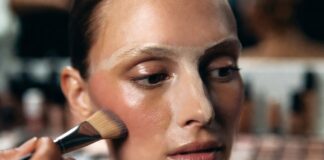Underpainting Is Back—Why Makeup Artists Are Reversing Foundation and Contour for a More Natural Finish Model's face mid-underpainting makeup application with cream contour blended along the cheekbone before a sheer foundation layer is applied, demonstrating the reverse contouring technique used by professional makeup artists.