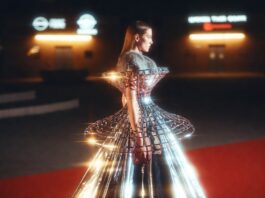 Zendaya’s Futuristic Red Carpet Era Is Defining 2026 Celebrity Fashion Female model in a chrome silver structured metallic gown with fur collar trim on a red carpet at night, illustrating Zendaya's futuristic fashion aesthetic and the metallic gown trend defining celebrity red carpet style in 2026.