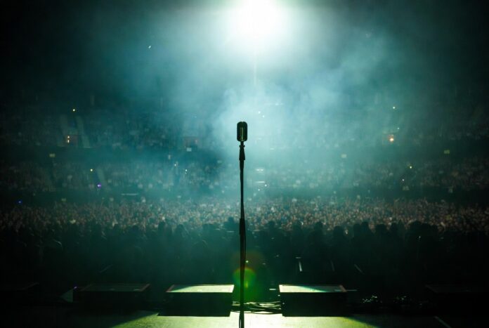 Billie Eilish New Album Alternative Pop 2026 A moody, atmospheric concert stage bathed in green and blue light evoking a Gen Z alternative pop superstar