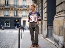 Blokecore Fashion Takes Over Paris Street Style With Vintage Football Jerseys A stylish person outside Paris Fashion Week in a vintage football jersey, tailored trousers, and Adidas Sambas