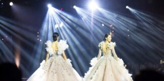 The Search for Fashion’s Next Supermodel Intensifies After Breakout Runway Season Model mid-stride in a dramatic feathered ball skirt on a Paris Fashion Week runway representing the breakout models 2026 season and the emergence of Awar Odhiang, Achol Ayor, and Stella Hanan as the next generation of luxury fashion stars