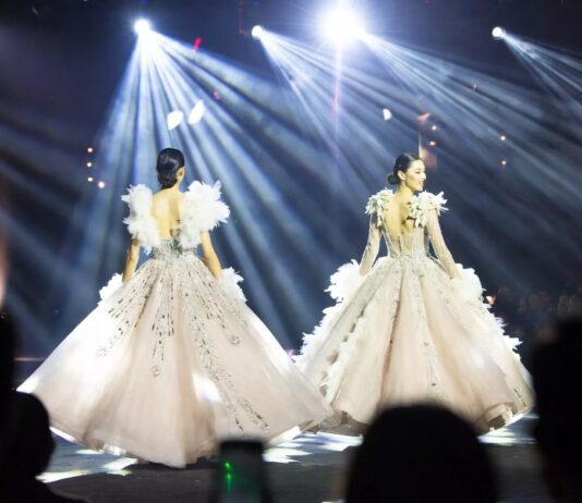 The Search for Fashion’s Next Supermodel Intensifies After Breakout Runway Season Model mid-stride in a dramatic feathered ball skirt on a Paris Fashion Week runway representing the breakout models 2026 season and the emergence of Awar Odhiang, Achol Ayor, and Stella Hanan as the next generation of luxury fashion stars