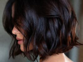 Woman with rich glossy dark espresso brunette long bob haircut representing the most requested celebrity haircut trend of summer 2026 evoking Katie Holmes hair and the luxury hair trends and glossy brunette hair aesthetic driving salon bookings in 2026