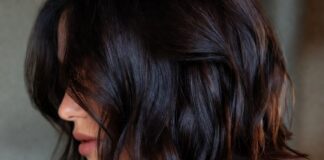 Woman with rich glossy dark espresso brunette long bob haircut representing the most requested celebrity haircut trend of summer 2026 evoking Katie Holmes hair and the luxury hair trends and glossy brunette hair aesthetic driving salon bookings in 2026