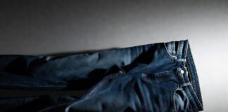 Luxury Denim Is Becoming Fashion’s Most Surprising Status Symbol Luxury denim jeans in deep indigo displayed on a clean editorial backdrop with soft lighting.