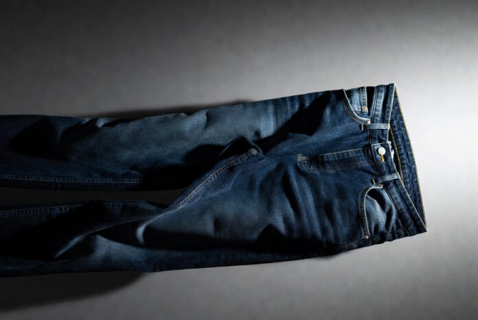 Luxury Denim Fashion Status Symbol 2026 Trend Luxury denim jeans in deep indigo displayed on a clean editorial backdrop with soft lighting.