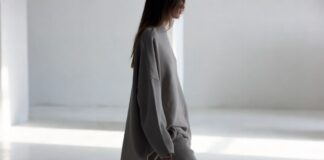 Pre-Fall 2026 Styling Tricks Are Influencing How Women Dress Right Now Model in a monochromatic oversized knit and matching trousers walking a clean editorial runway.