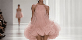 Model in a sculptural bubble hem dress in ice-cream pink tulle and organza on an SS26 fashion runway.