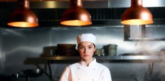 Young female chef in a warm restaurant kitchen reflecting the emotional force of prestige television