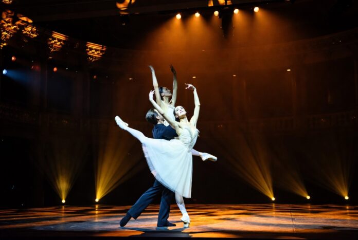 Ballet dancers in white tutu and classical Swan Lake staging on the Metropolitan Opera House stage representing American Ballet Theatre's 2026 summer season with Swan Lake, Don Quixote, Onegin, and Sylvia at Lincoln Center