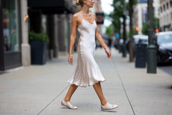 Ballet Sneakers and the Sneakerina Trend — The Defining Street Style Shoe of Summer 2026 Woman wearing ballet sneakers in a street style 2026 setting representing the sneakerina trend combining ballet flat elegance with sneaker comfort as worn by celebrities in NYC street style and fashion week street style including Adidas ballet sneakers Puma ballet sneakers and Louis Vuitton sneakerina.