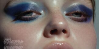 Editorial beauty close-up featuring bold blue eyeshadow and juicy blurred lips against luminous skin representing the beauty trends 2026 moment including cellness skincare glow bold makeup trend blue eyeshadow trend and the departure from minimalist beauty aesthetics.