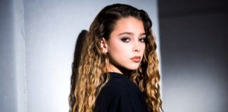 Alex Consani’s Rise Signals a New Era for the Modern Supermodel Model in a sleek runway-ready look poses against a minimal studio backdrop with soft lighting.