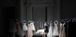 Luxury fashion atelier setting evoking the Jonathan Anderson Dior creative directorship era with precise architectural garments and haute couture craftsmanship representing the most consequential designer appointment in luxury fashion in 2025 2026
