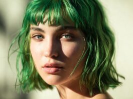 Model with vibrant saturated neon green hair in warm summer editorial lighting representing the neon green hair trend and bold hair colors summer 2026 comeback in beauty culture and fashion