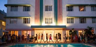 Models on a runway built over an Art Deco hotel pool in warm evening light representing PARAISO RISE Miami Swim Week 2026 at the Kimpton Surfcomber Hotel and the immersive fashion experience format redefining pool runway fashion shows