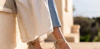 Woman wearing natural raffia wedge espadrilles in Mediterranean coastal light representing the wedge espadrilles 2026 trend and Princess Diana fashion royal style inspiration behind summer shoe trends 2026