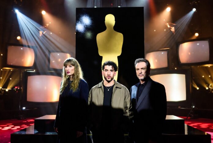 2026 Emmy Nominations Make Swift and Bad Bunny Big Gold awards statuette scene with TV screens, concert lights and red-carpet reflections