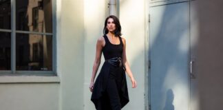 Black skirt-trouser look paired with a fitted tank, statement waist belt and patterned slingback heels