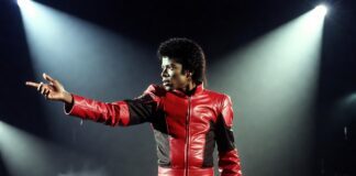 Jaafar Jackson portrays Michael Jackson in a red stage jacket from the billion-dollar biopic Michael.