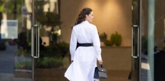 Polished white shirtdress with black belt and kitten heels in a refined summer setting