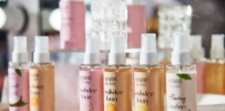Colorful body mist bottles styled in a glossy Gen Z beauty editorial fragrance scene