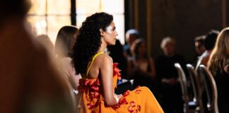 Priyanka Chopra Dior Turns Paris Front Row Into Global Star Power Vivid orange couture dress with floral petal details at a Paris front-row fashion show