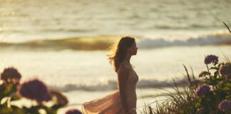 The Summer I Turned Pretty: The Record-Breaking Phenomenon and What Comes Next A dreamy summer beach scene evoking a coming-of-age romance with a young woman by the ocean at golden hour